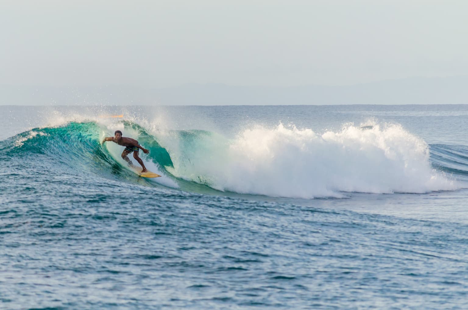 Local surfer riding a wave captured by Mati Olivieri