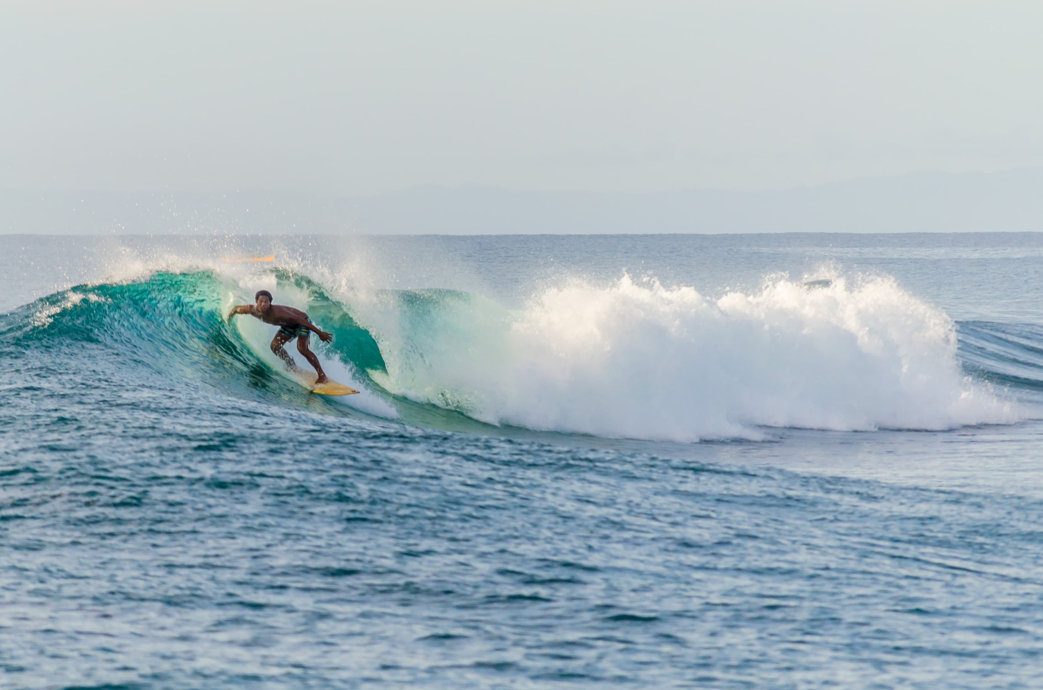 Local surfer riding a wave captured by Mati Olivieri